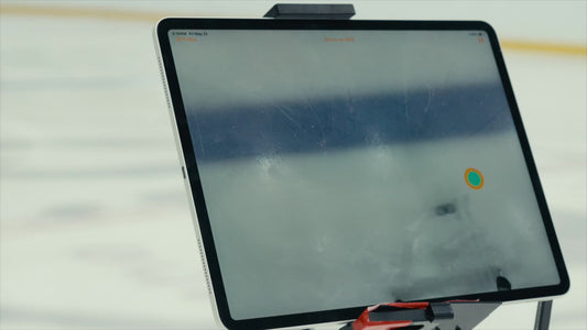 Tablet mounted on a tripod at the rink tracking a hockey shot, an alternative to a radar gun