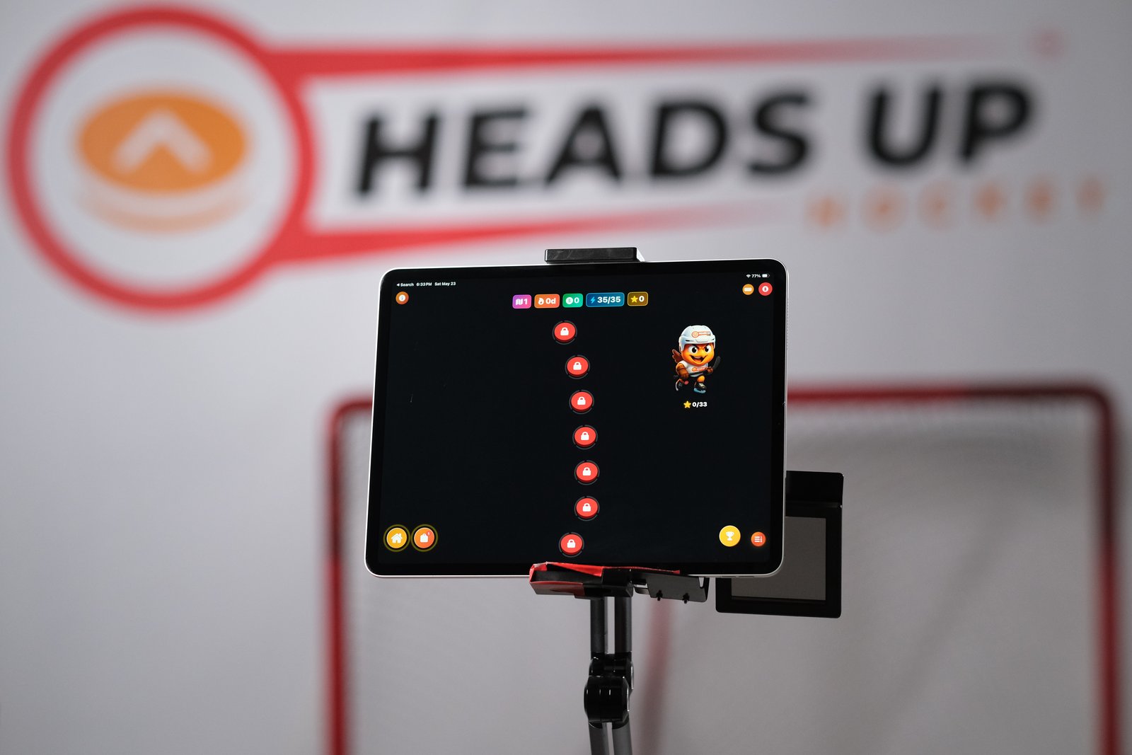 Tablet on a stand running the Heads Up Crush stickhandling trainer with glowing dot targets