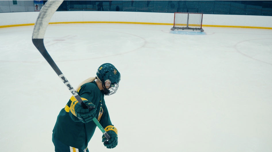 Hockey player on the ice loading up a shot